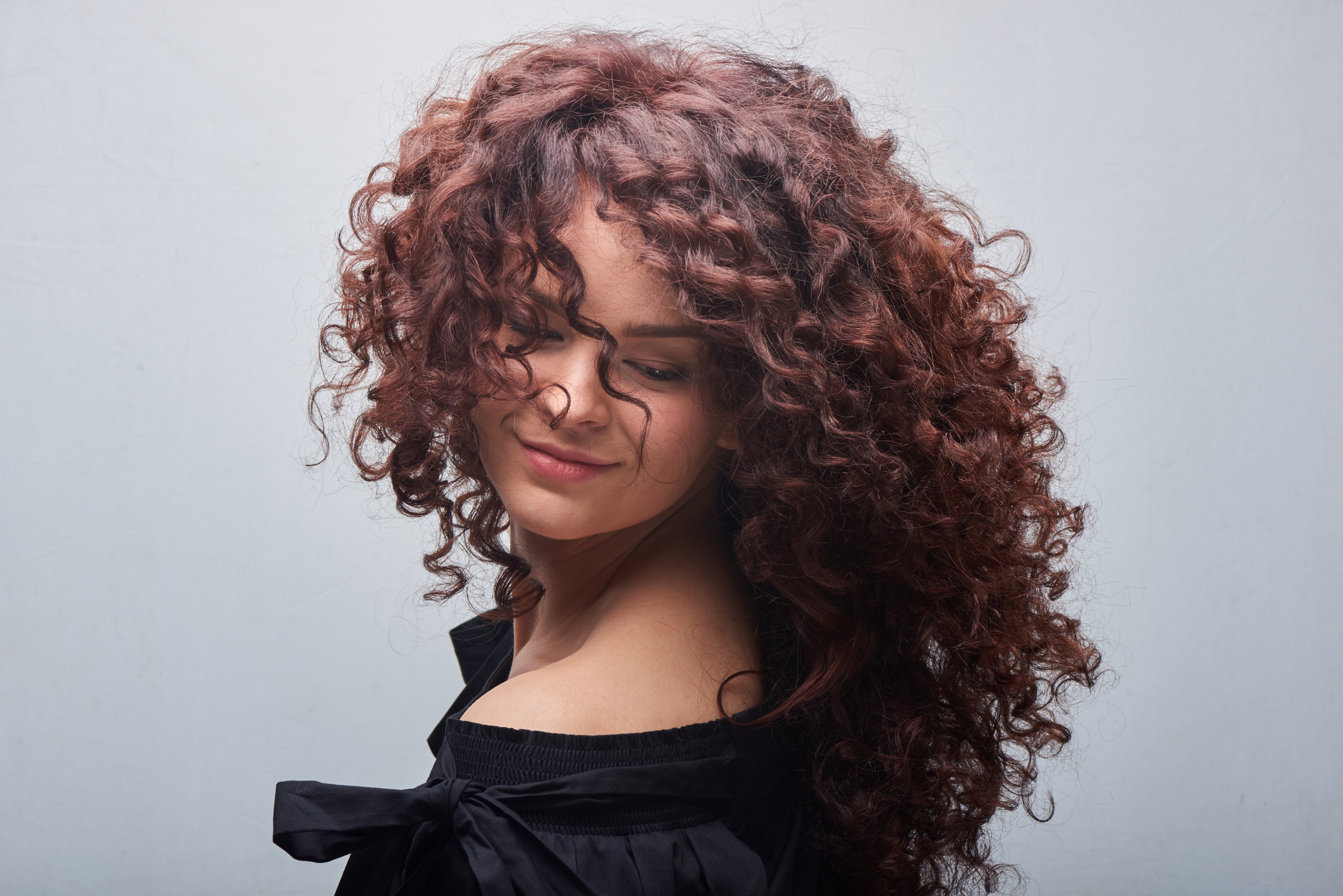 Mulher com o cabelo cacheado