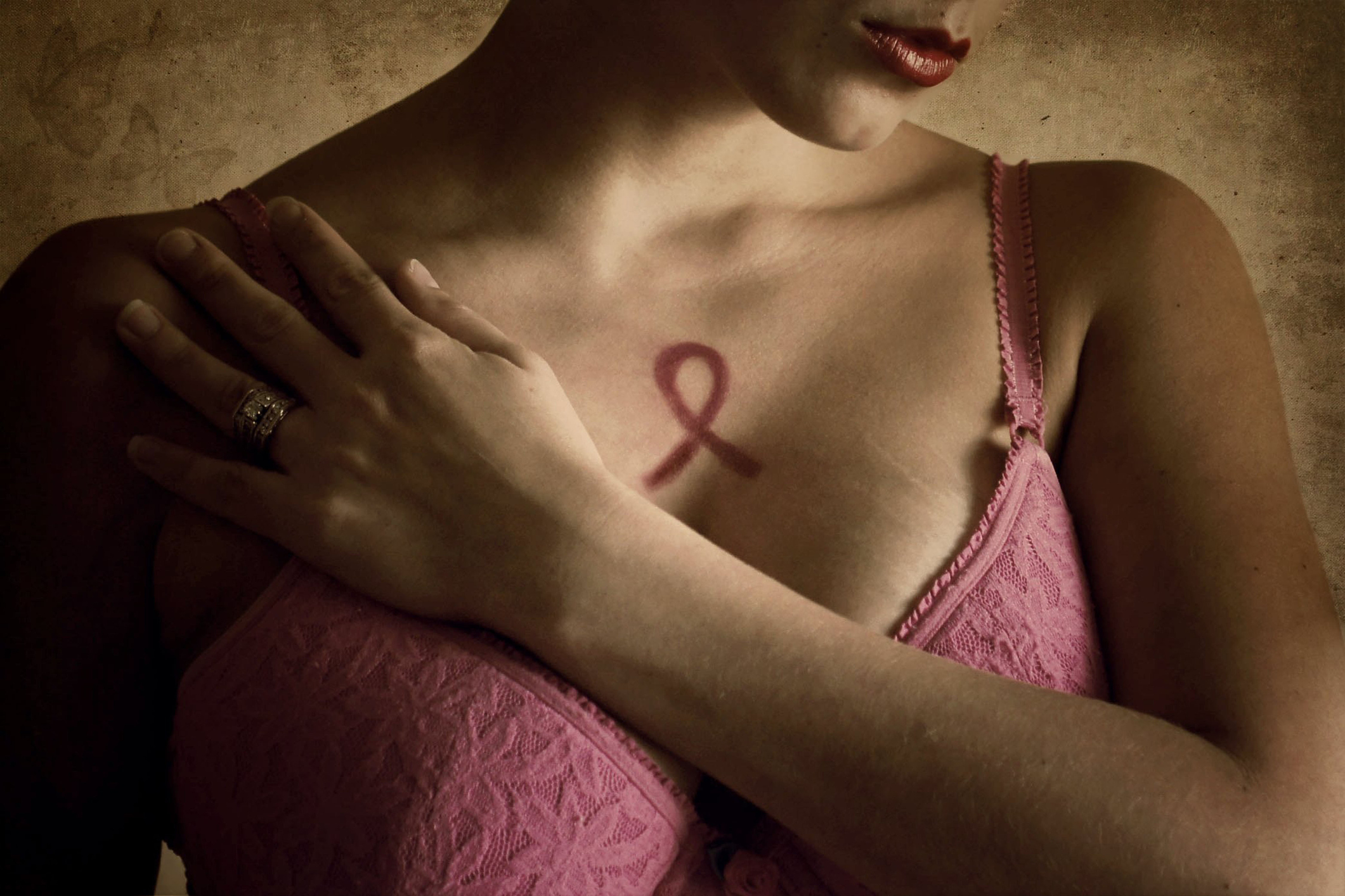 Woman in pink bra representing breast cancer awareness month.