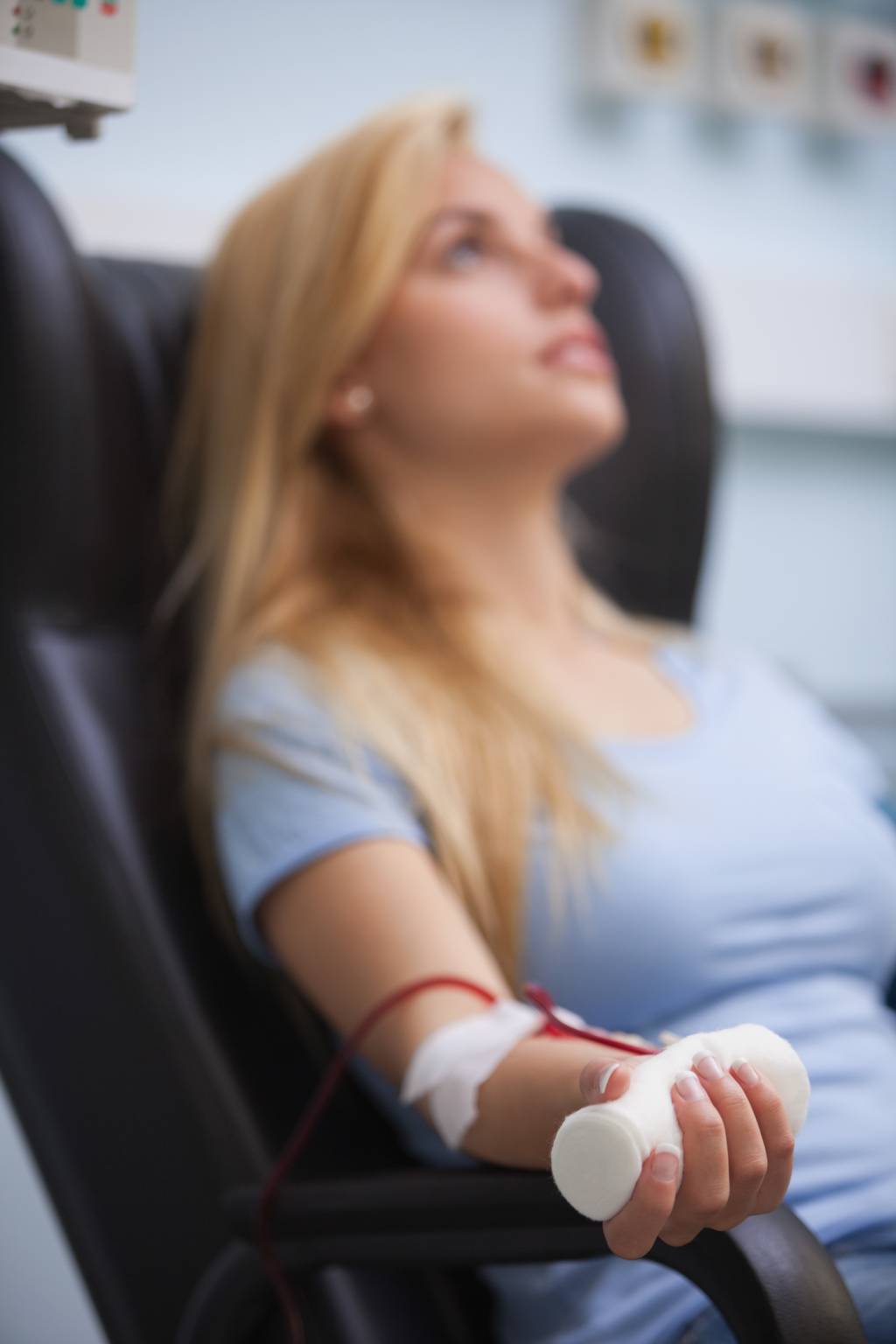 Woman sitting back while getting dialysis