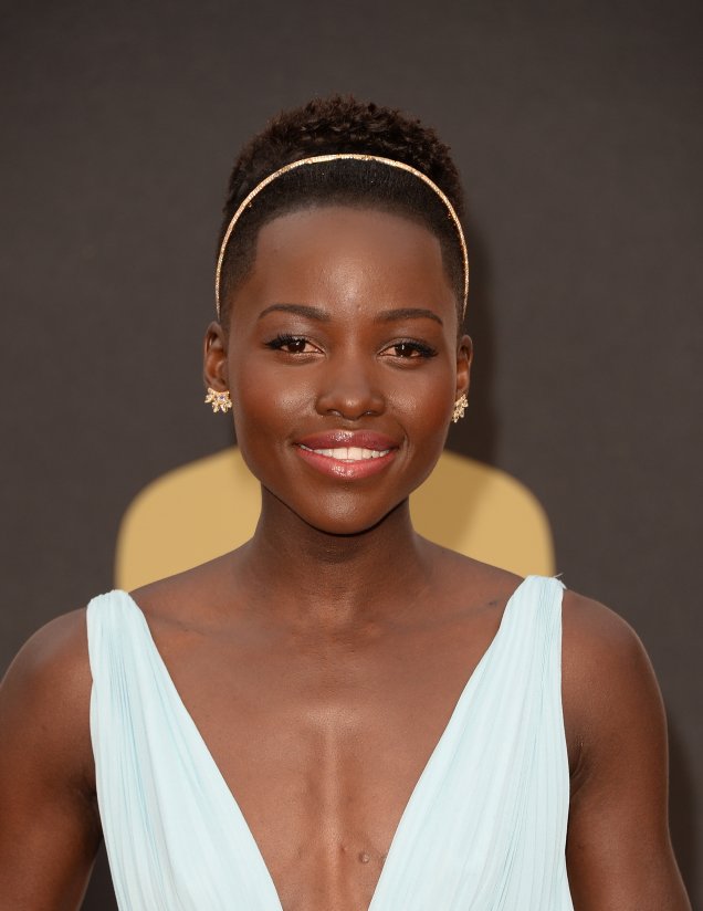 Os lábios em tom coral e a fina tiara dourada deram o toque necessário para o vestido fluido, digno de princesa, de Lupita Nyong'o. Os lábios em tom coral e a fina tiara dourada deram o toque necessário para o vestido fluido, digno de princesa, de Lupita Nyong'o.