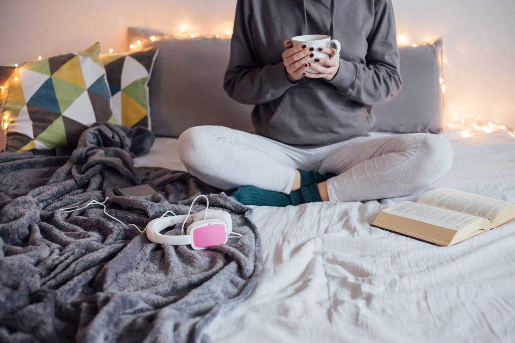 Girl drinking hot tea in bed