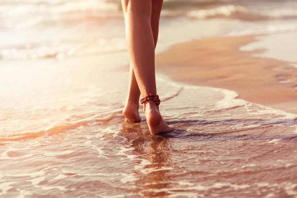 walking on beach barefoot during sunset