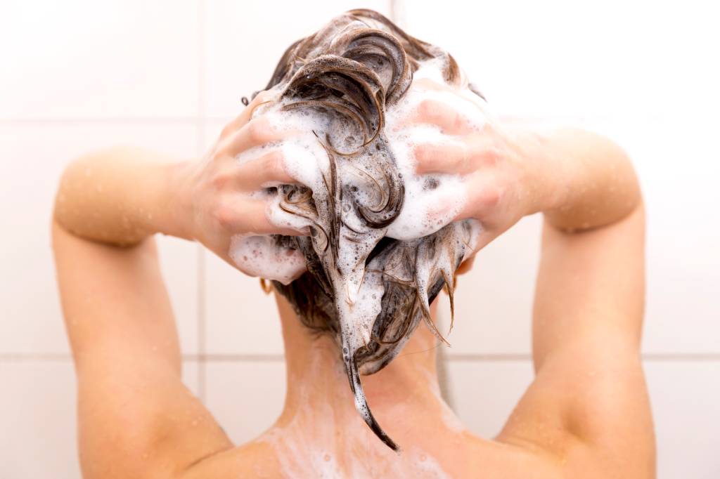 Woman washing her hair in shower Woman washing her hair in shower