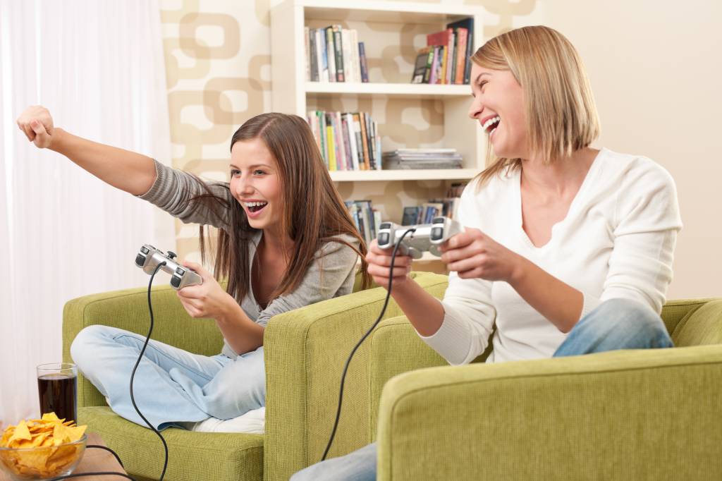 Students – Two female teenager playing video TV game