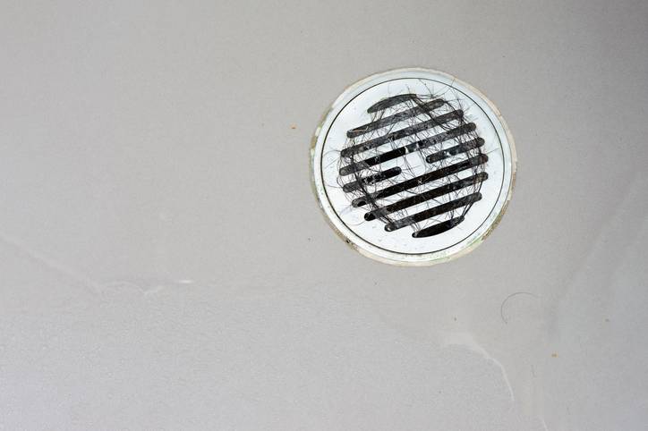 thinkstockphotos-502354690 Hair clump in bath drain.