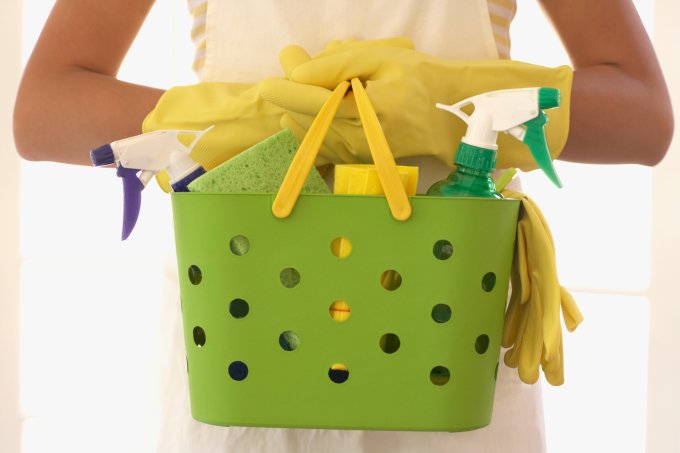 Hispanic woman carrying cleaning supplies