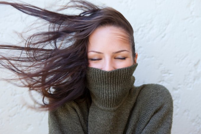 Woman with polar neck jumper and wind in her hair
