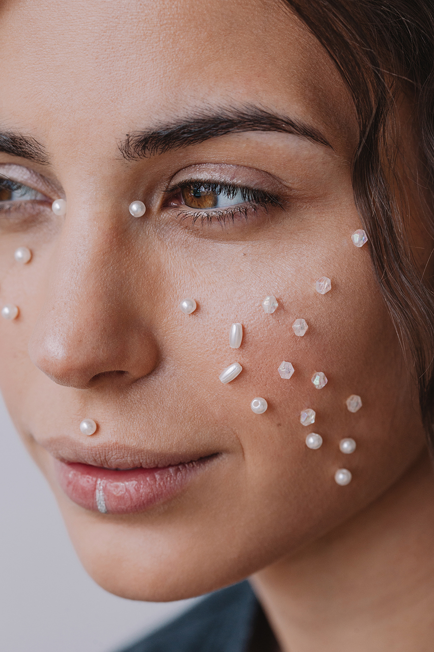 Close-up of a woman with pearls on her face Close-up of a woman with pearls on her face