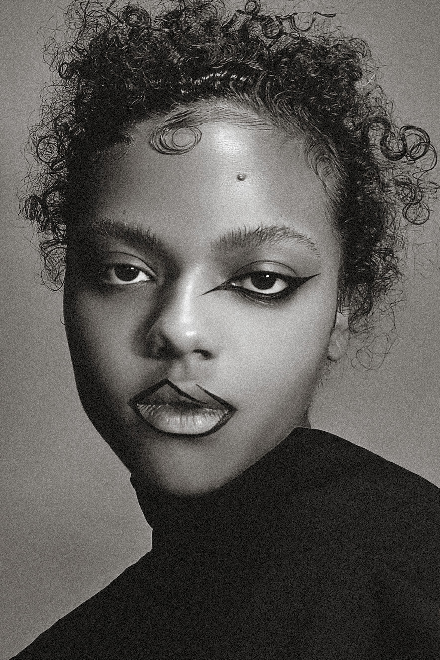 Mulher negra olha para a c&acirc;mera. Ela tem no olho um desenho feito com delineador