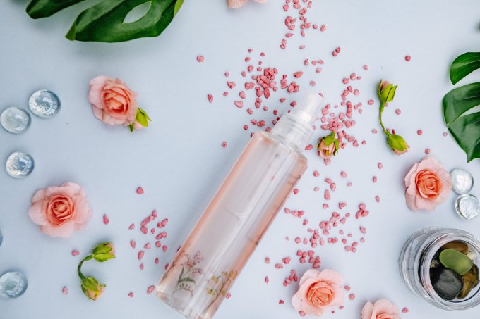 perfume bottle and rose petals top view.Pastel tones
