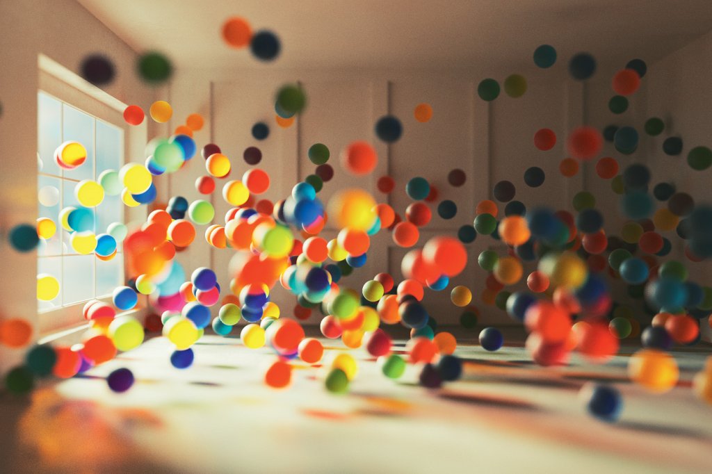 Bolas coloridas em movimento numa sala vazia