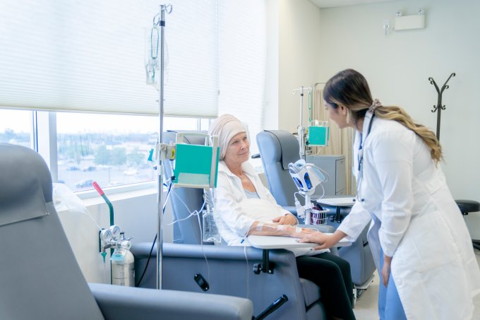 Senior woman with cancer talking to a female oncologist