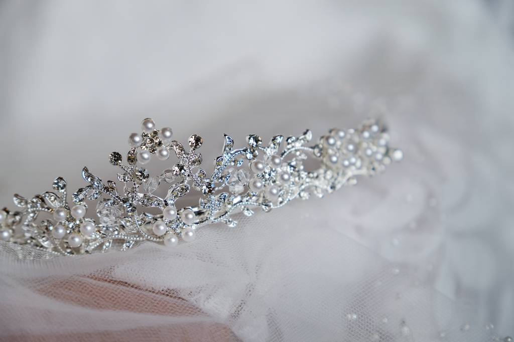 Beautiful bride’s crown is on the veil, close-up. Wedding day. Morning bride. Casamentos coroas
