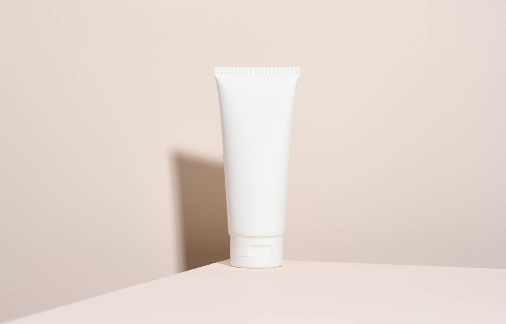 Empty White Plastic Tubes For Cosmetics. Packaging For Cream, Gel, Serum, Advertising And Creme