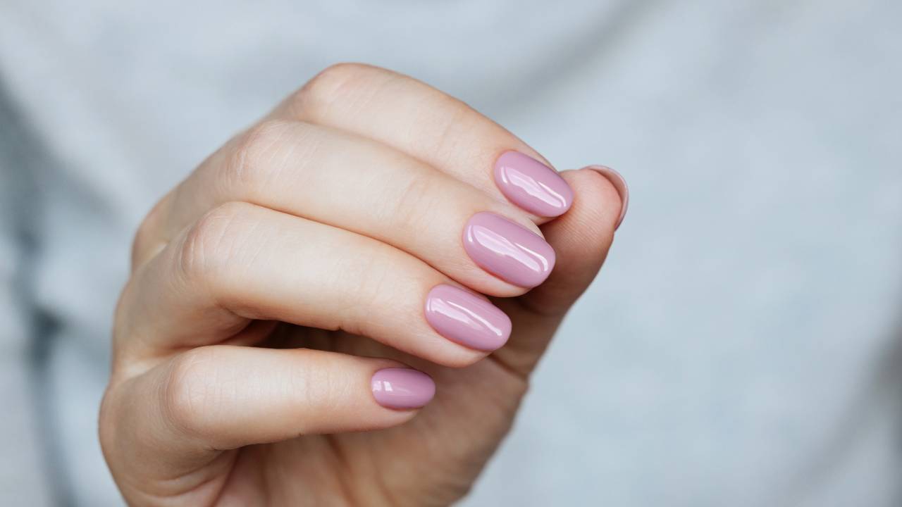 Mulher exibindo unhas feitas