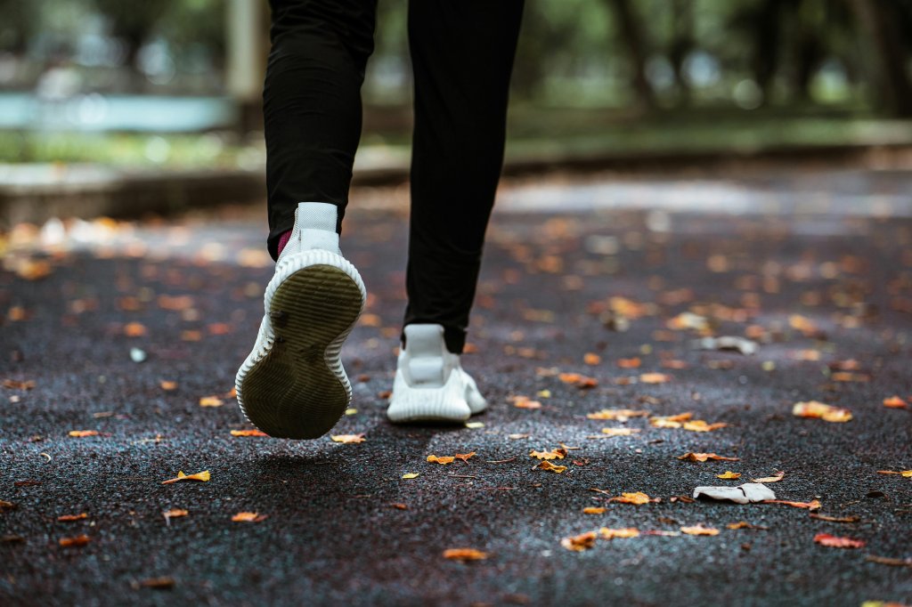 Imagem dos pés e das penas de uma mulher correndo