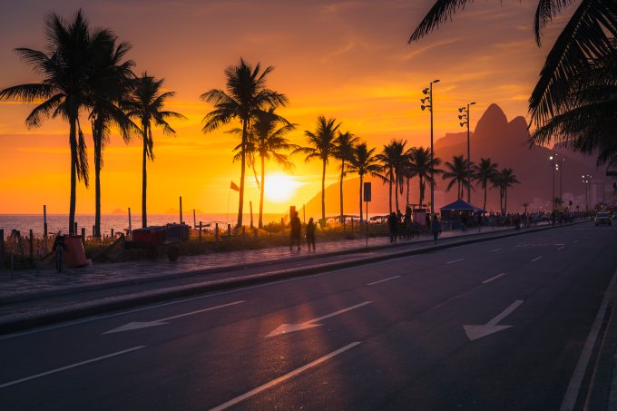 Sunset over Ipanema Beach with palms in Rio de Janeiro, Brazil