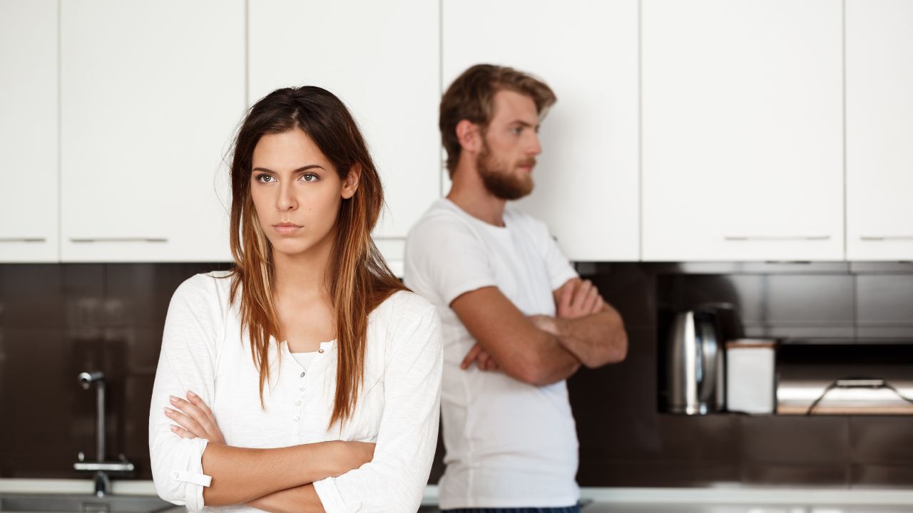 Imagem de homem e mulher de braços cruzados em uma cozinha