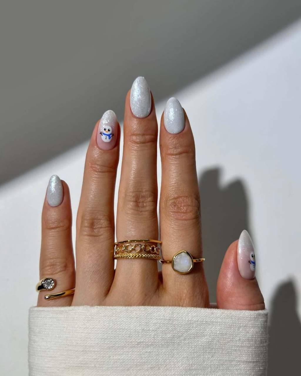 unhas-tematicas-inverno (7) Imagem de mão branca exibindo nail art azul claro temática para o inverno.