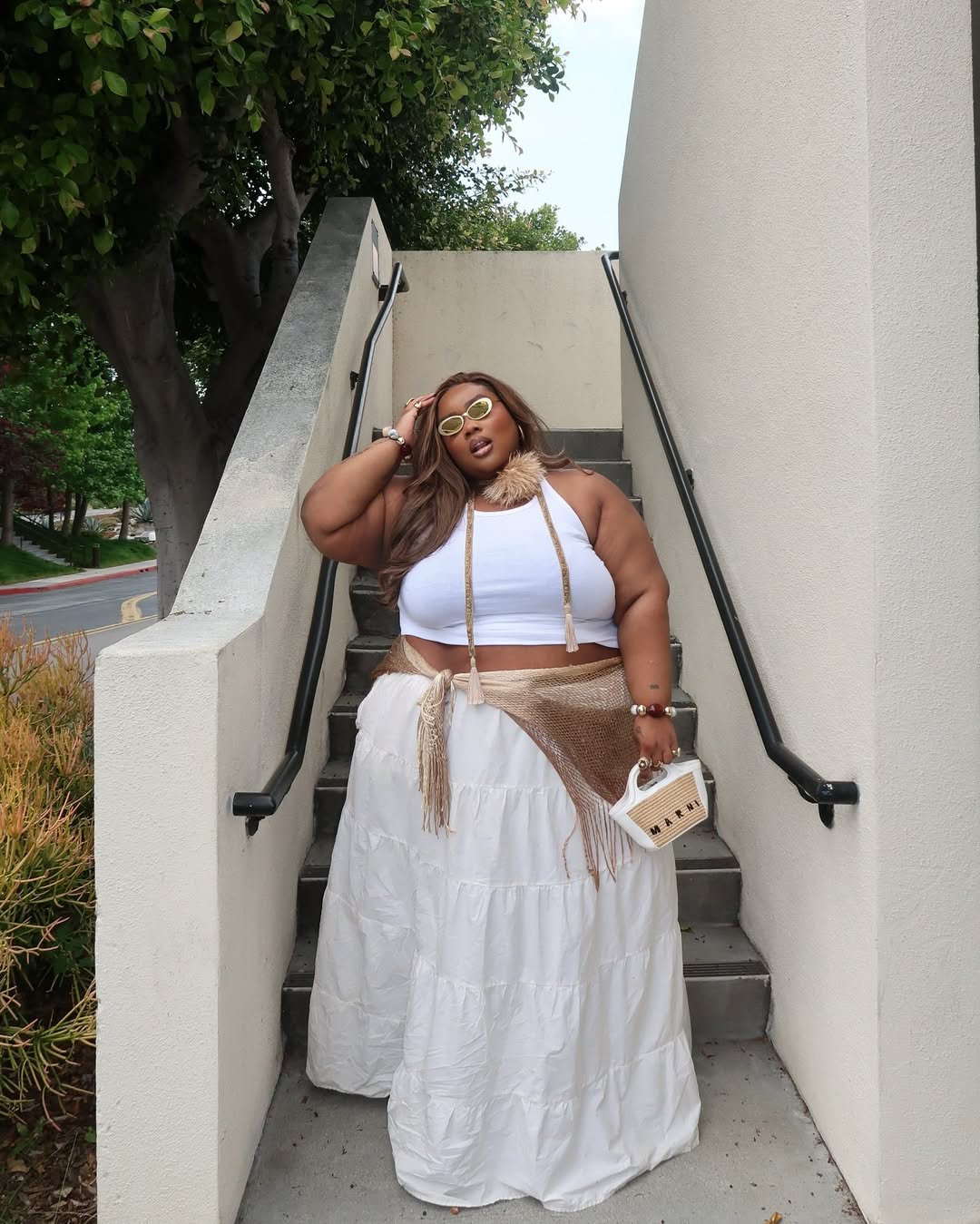 Look plus size com regata cropped e saia longa fluída branca