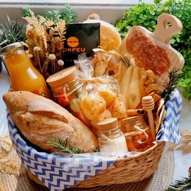 Cesta de presente com pães, suco, doces e itens gourmet, decorada com elementos naturais.