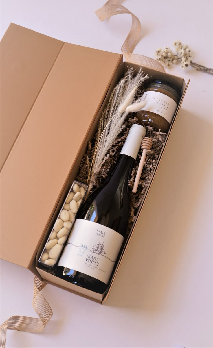 Caixa de presente elegante com vinho, mel, doces e flores secas.