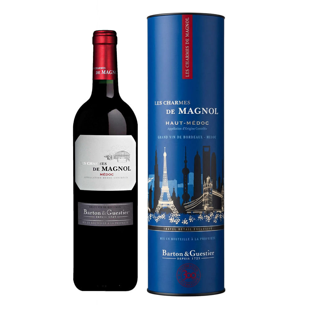 Garrafa de vinho tinto Les Charmes de Magnol com r&oacute;tulo branco e vermelho, ao lado de uma caixa cil&iacute;ndrica azul escura com ilustra&ccedil;&otilde;es de pontos tur&iacute;sticos e o mesmo nome do vinho