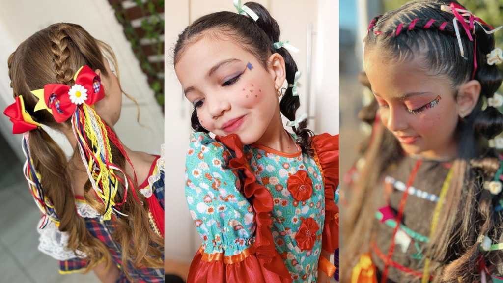 Três meninas com penteados e maquiagens típicas de festa junina. A primeira tem tranças e maria-chiquinhas com laços coloridos. A segunda, com sardinhas pintadas e bandeirinha no rosto, usa vestido florido. A terceira, com tranças e fitas no cabelo, tem maquiagem rosa e bandeirinhas no rosto