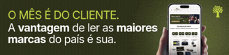 PAYWALL-CTA-328-x-79-px Mão segurando um smartphone com aplicativo de notícias exibindo O mês é do cliente. A vantagem de ler as maiores marcas do país é sua em fundo verde-escuro, com um ícone de árvore no canto superior direito
