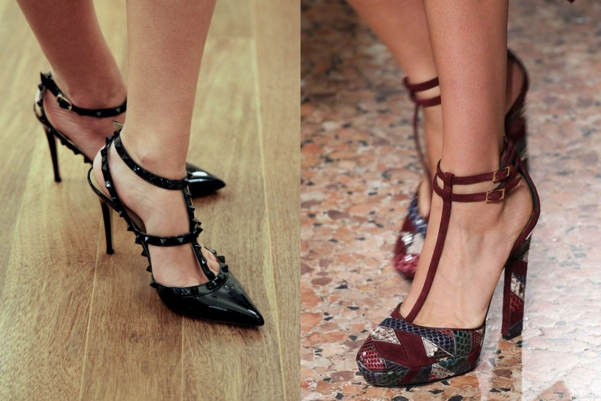 Duas mulheres exibem sapatos de salto alto. À esquerda, um sapato preto de bico fino com tiras e tachas sobre piso de madeira. À direita, um sapato com estampa geométrica em tons terrosos e tiras no tornozelo sobre piso de mármore
